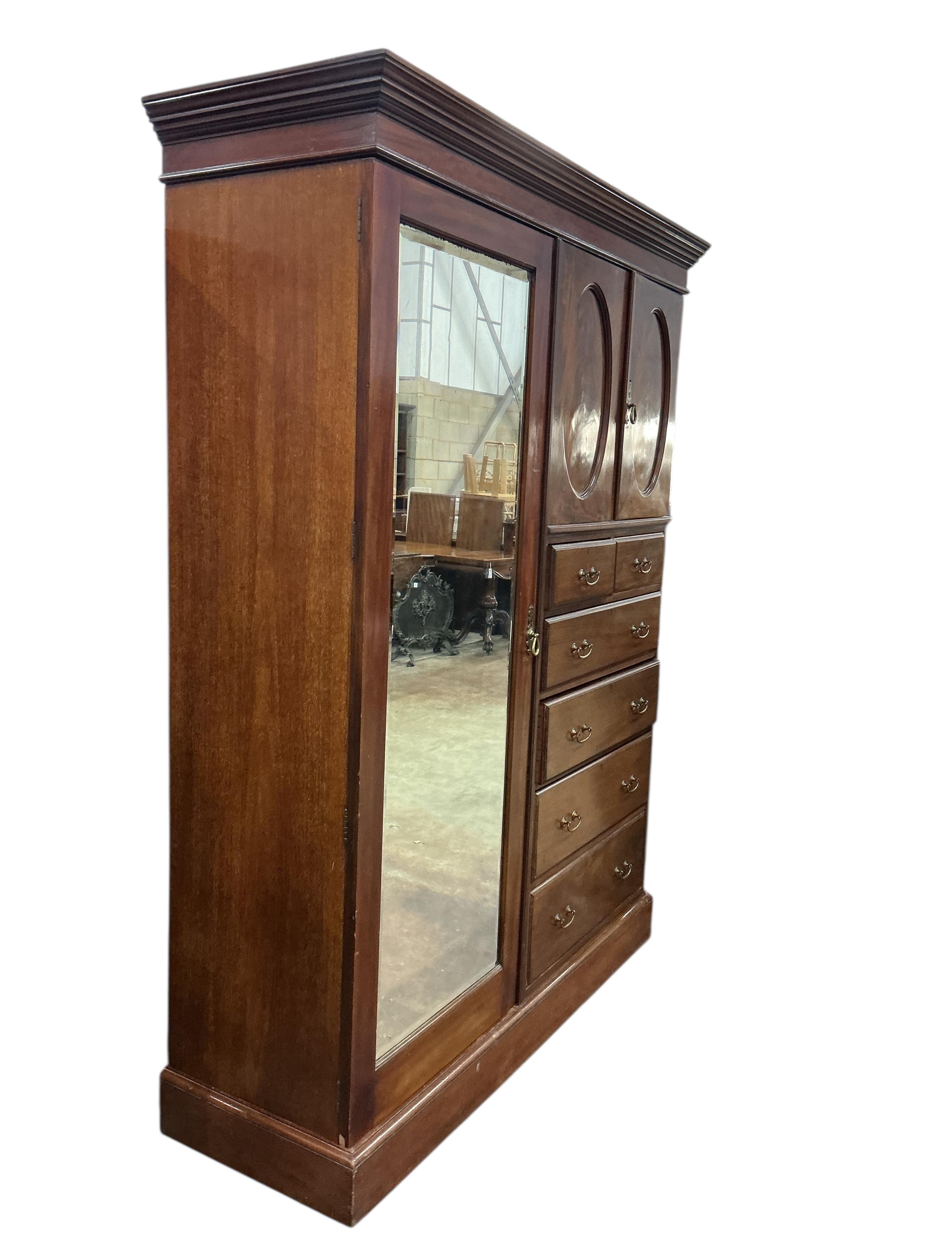 An early 20th century mahogany mirrored compactum wardrobe, width 154cm, depth 50cm, height 208cm